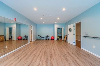 Fitness studio with exercise equipment and mirrors
