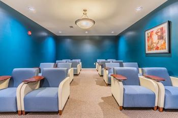 Theater room with recliners and blue lighting