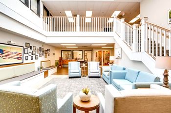 A living room with a staircase and a couch.