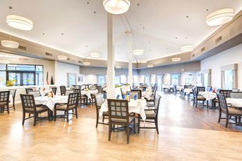 A restaurant with tables and chairs set up for dining.