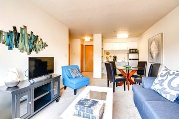 King City apartment for rent - A living room with a blue couch and a television.
