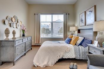 Spacious bedroom with contemporary furnishings and natural lighting