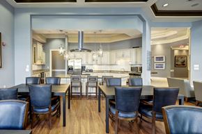 Ellicott City apartment for rent - Community dining room with kitchen and blue chairs at Regency Crest Apartments, Maryland, 21043