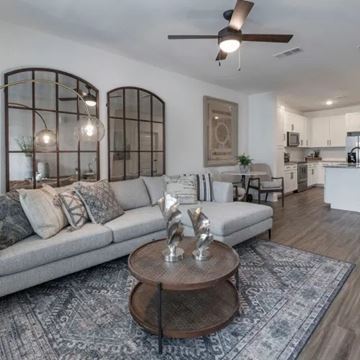 Ponte Vedra apartment for rent - A modern living room with a grey sofa and a wooden coffee table.