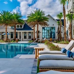 Ponte Vedra apartment for rent - A poolside area with lounge chairs and a table. at Atwater at Nocatee Apartments, Florida, 32081