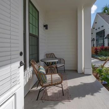 A patio with a table and chairs.
