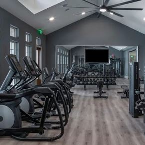 Ponte Vedra apartment for rent - A gym with treadmills, elliptical machines, and a television. at Atwater at Nocatee Apartments, Toledo, FL