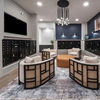 A modern living room with a grey carpet and a black and white color scheme.