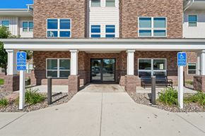 Faribault apartment for rent - A building with a brick facade and a glass door entrance.