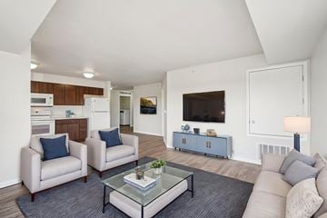 Shakopee apartment for rent - A living room with a glass coffee table and two chairs.