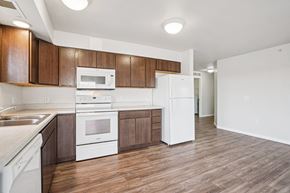 Shakopee apartment for rent - A kitchen with white appliances and wooden cabinets.