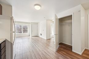 Bloomington apartment for rent - A spacious room with wooden floors and white walls.