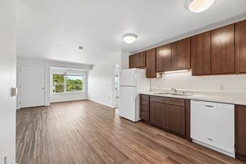 Faribault apartment for rent - A kitchen with white appliances and wooden cabinets.