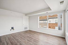Shakopee apartment for rent - A room with a window showing a view of a building.