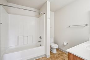 Vadnais Heights apartment for rent - A white bathroom with a toilet, sink, and bathtub.