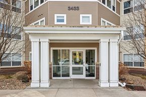 Rochester apartment for rent - A building with a brown facade and a white entrance.