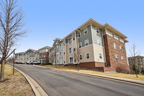 Forest Lake apartment for rent - A street view of a residential area with apartment buildings on the side.