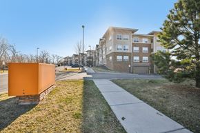 Savage apartment for rent - A sidewalk leads to a building with a brown and beige facade.