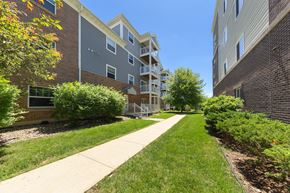 Rochester apartment for rent - A long concrete walkway separates two apartment buildings.