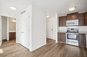 Eagan apartment for rent - A kitchen with a white refrigerator, wooden cabinets, and a stainless steel stove.