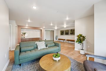 Burnsville apartment for rent - A living room with a green couch and a wooden coffee table.