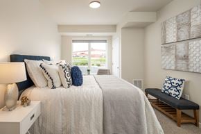 Burnsville apartment for rent - a bedroom with a large bed and a window