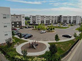 Rochester apartment for rent - an aerial view of an apartment complex with cars in a parking lot