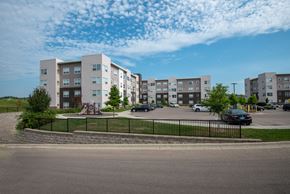 Rochester apartment for rent - A large apartment complex with a playground in the front.