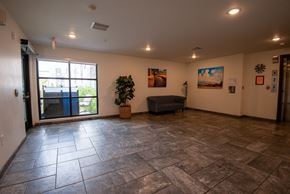 Rochester apartment for rent - a large living room with a sliding glass door and tile floors