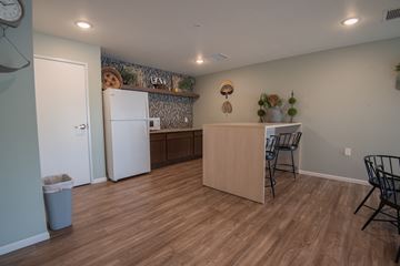 Rochester apartment for rent - a kitchen and dining area with a refrigerator and a table and chairs