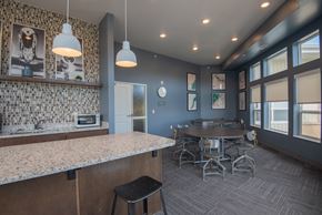 Rochester apartment for rent - A kitchen with a bar area and a dining table.