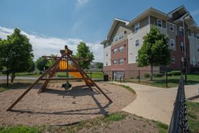 Rochester apartment for rent - an empty playground with an apartment building in the background