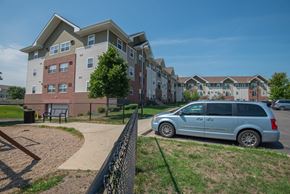 Rochester apartment for rent - a van parked in front of an apartment building