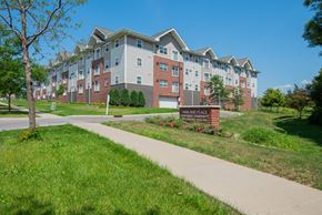 Rochester apartment for rent - an apartment building with a sidewalk in front of it