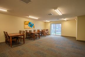 Rochester apartment for rent - a dining room with tables and chairs and a sliding glass door