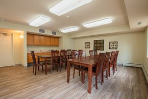 Rochester apartment for rent - a dining room with wooden tables and chairs and a kitchen