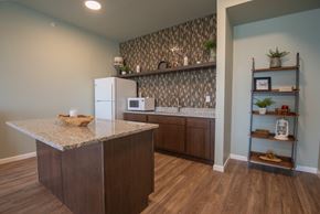 Rochester apartment for rent - A kitchen with a granite countertop and a refrigerator.