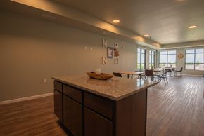 Rochester apartment for rent - A kitchen with a granite countertop and wooden floors.