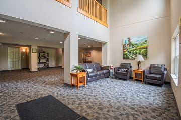 Waconia apartment for rent - A living room with a grey carpet and a painting on the wall.
