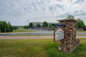 Waconia apartment for rent - A stone pillar with a sign on it that says Interlaken Place Apartments.