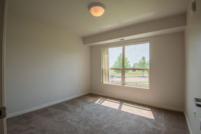 Mankato apartment for rent - A room with a carpeted floor and a window letting in sunlight.