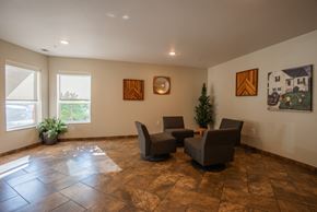 Mounds View apartment for rent - A living room with brown tiled floors and a small Christmas tree.