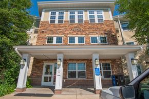 Forest Lake apartment for rent - A brick building with the number 8830 on it.