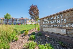 Hugo apartment for rent - A sign for Rosemary Apartments is in front of a grassy area.