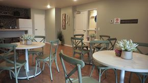 Rochester apartment for rent - a dining room with tables and chairs and a kitchen