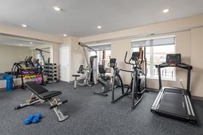 Burnsville apartment for rent - a gym with treadmills and other exercise equipment in a room with windows