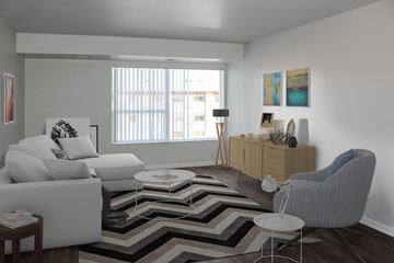 Bloomington apartment for rent - a living room with white furniture and a geometric rug