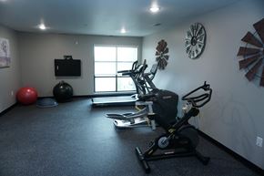 Rochester apartment for rent - a gym with exercise equipment in a room with a window