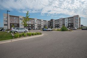 Rochester apartment for rent - A parking lot in front of apartment buildings.
