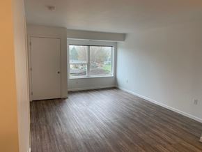 Faribault apartment for rent - A room with a wooden floor and a large window.